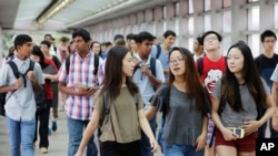 FILE - Students arrive for the first day of school at Stuyvesant High School in New York, Sept. 9, 2015.