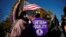People hold flags and signs at a demonstration as the U.S. Supreme Court hears arguments over a Republican-backed ban in Tennessee on gender-affirming medical care for transgender minors, outside the court in Washington, Dec. 4, 2024. 