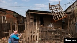 Andrew Harper, asesor climático de la agencia de la ONU para los refugiados (ACNUR), fotografía una casa parcialmente destruida por las inundaciones que azotaron Porto Alegre, en el estado de Rio Grande do Sul, Brasil. Foto captada el 23 de junio de 2024.