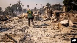 Marvin Meador walks on the remains of his fire-ravaged property after the Mountain Fire swept through, Nov. 7, 2024, in Camarillo, Calif.