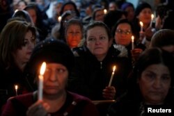 Iraqi Christians attend a Mass on Christmas eve at the Mar Shimoni church in the town of Bartella, east of Mosul, Dec. 24, 2016.