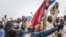 FILE - Protesters wave Russian and Malian flags in Bamako, during a demonstration against French influence in the country, May 27, 2021. Russian soldiers have deployed to Timbuktu to train Malian forces, the Malian army said Jan. 6, 2022.