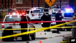 FILE - Crime scene investigators collect evidence from the pavement as police respond to an attack on campus at Ohio State University, in Columbus, Ohio, Nov. 28, 2016. 