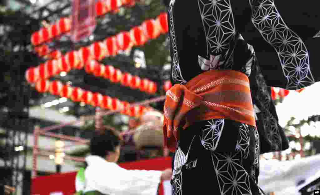 A woman dances in &quot;bon-odori,&quot; a traditional summer dance at a festival in Tokyo. The festival is held to celebrate and promote such Japanese traditions to help the city cool down.