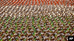 FILE - Members of Iran's Revolutionary Guard march in front of the mausoleum of the late revolutionary founder Ayatollah Khomeini outside Tehran, Sept. 2014.