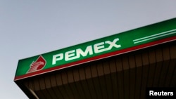 FILE - A Pemex gas station is seen in Mexico City. Pemex said the pipeline did not explode, but that the blast was from a nearby stolen fuel tank.