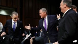 Acting FBI Director Andrew McCabe, left, is greeted on Capitol Hill, May 11, 2017, by Senate Intelligence Committee Chairman Sen. Richard Burr, R-N.C., next to CIA Director Mike Pompeo prior to a hearing on major threats facing the U.S. 