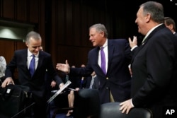 Acting FBI Director Andrew McCabe, left, is greeted on Capitol Hill, May 11, 2017, by Senate Intelligence Committee Chairman Sen. Richard Burr, R-N.C., next to CIA Director Mike Pompeo prior to a hearing on major threats facing the U.S.