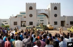 Sudanese demonstrators gather to protest against the army's announcement that President Omar al-Bashir would be replaced by a military-led transitional council, outside the Defense Ministry in Khartoum, Sudan, April 12, 2019.