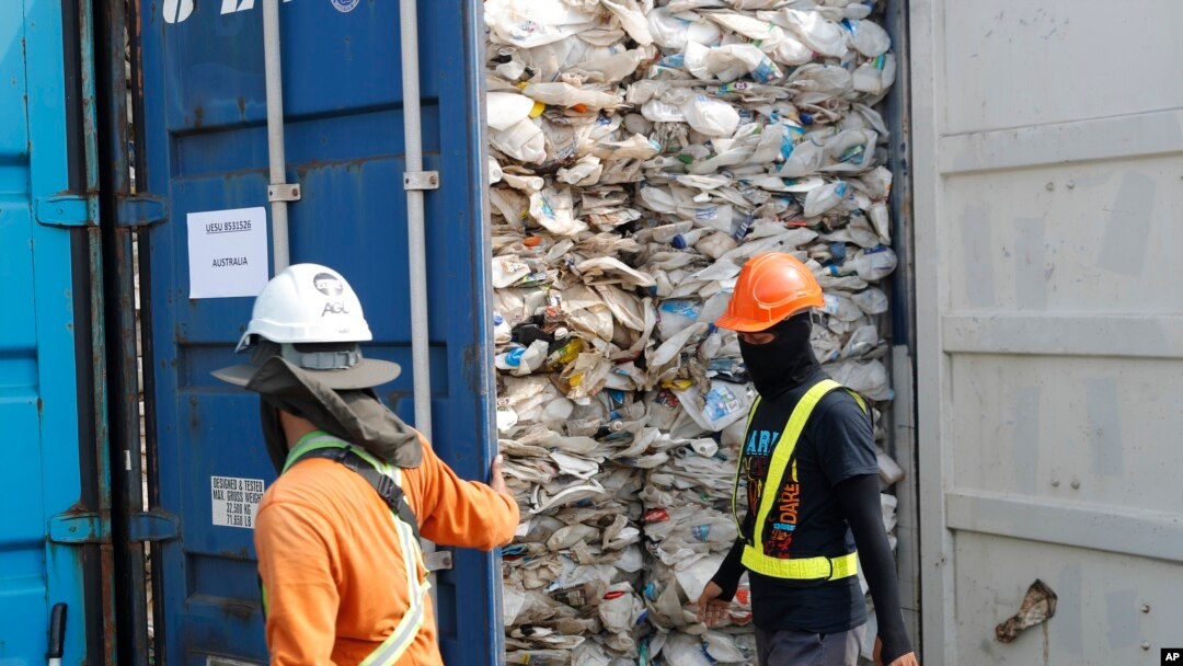 Pekerja membuka kontainer penuh plastik yang tidak dapat didaur ulang, yang ditahan oleh pihak berwenang di pelabuhan barat di Klang, Malaysia, Selasa, 28 Mei 2019. (Foto: dok).
