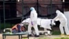 Medical personnel transport a body from a refrigerated container at Kingsbrook Jewish Medical Center, April 8, 2020, in the Brooklyn borough of New York. 