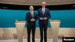 Social Democratic Party Chancellor Olaf Scholz and his conservative rival of the Christian Democratic Union Friedrich Merz are pictured in a studio of the ARD and ZDF television broadcasters ahead of their first TV debate in Berlin, Germany, Feb. 9, 2025.