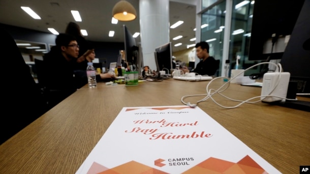 FILE - Employees of Chatting Cat company, a startup and ventures investors, work during a media tour at the Google campus in Seoul, South Korea, May 8, 2015. Seoul is the site of Google's first campus for startups and entrepreneurs in Asia.