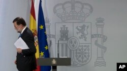 Spain's Prime Minister Mariano Rajoy leaves after a news conference in Madrid, Spain, Dec. 22, 2017.