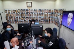 Software engineers work on a facial recognition program that identifies people when they wear a face mask at the development lab of the Chinese electronics manufacturer Hanwang (Hanvon) Technology in Beijing.