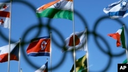 The North Korean flag, left center, flies amongst flags from many nations as they fly at the Olympic Village at the 2018 Winter Olympics in Gangneung, South Korea, Feb. 1, 2018.