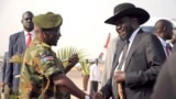 FILE - South Sudan's President Salva Kiir (R) is received by Chief of General Staff of the Sudan People's Liberation Army (SPLA) Paul Malong Awan at the airport in Juba, March 6, 2015, upon arriving after attending peace talks with rebel leader Riek Machar in Ethiopia's capital Addis Ababa.