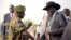 FILE - South Sudan's President Salva Kiir (R) is received by Chief of General Staff of the Sudan People's Liberation Army (SPLA) Paul Malong Awan at the airport in Juba, March 6, 2015, upon arriving after attending peace talks with rebel leader Riek Machar in Ethiopia's capital Addis Ababa.