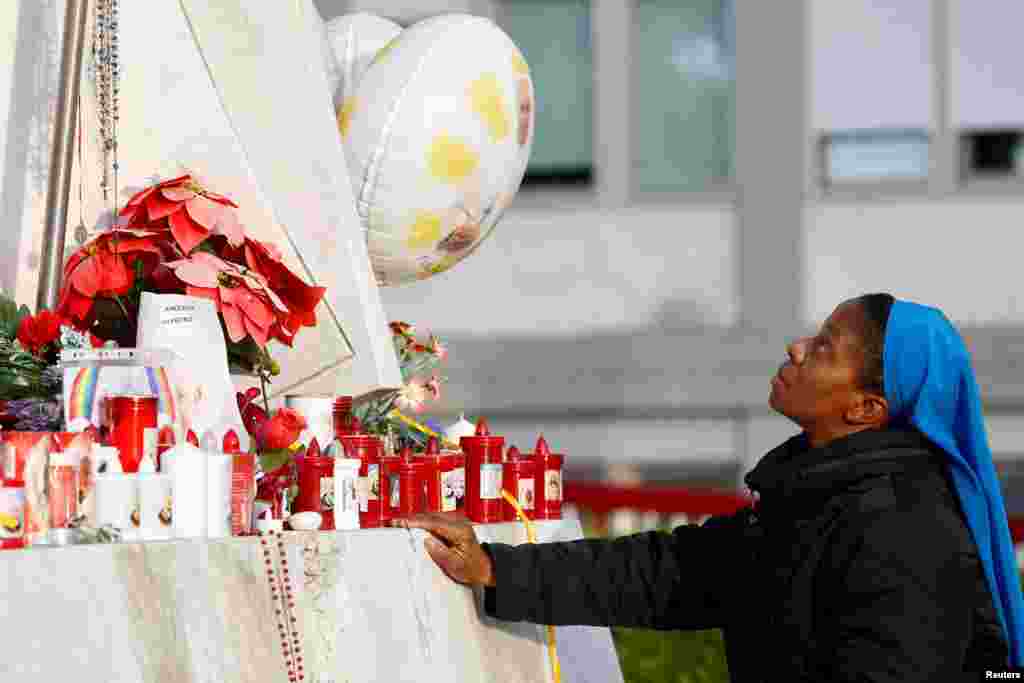 A nun prays at the base of the statue of the late Pope John Paul II outside Gemelli Hospital in Rome, Italy, where Pope Francis has been admitted for treatment.