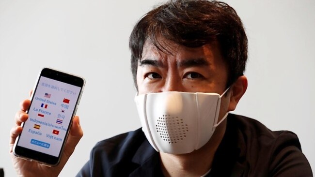 Japanese startup Donut Robotics' CEO Taisuke Ono shows the c-mask and its mobile phone application during a demonstration in Tokyo, Japan June 23, 2020. (REUTERS/Kim Kyung-Hoon)