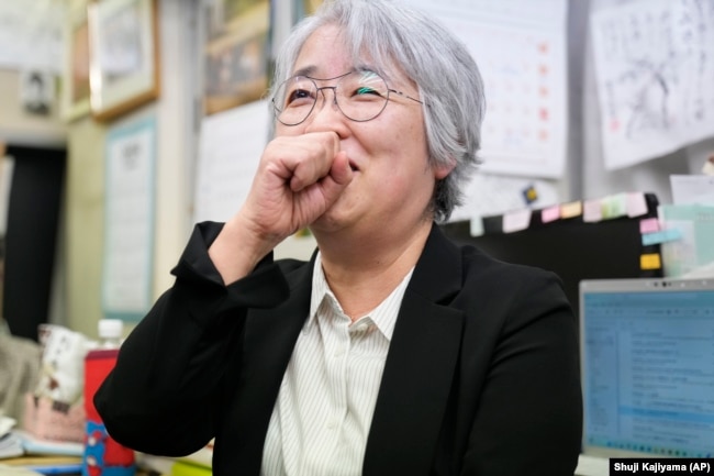 Masako Kudo, an official of Nihon Hidankyo reacts as she speaks to media members at its Tokyo office in Tokyo, Friday, Oct. 11, 2024. (AP Photo/Shuji Kajiyama)