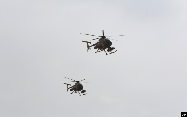 FILE - U.S.-made MD-530 Helicopters fly over the Hamid Karzai International Airport during a display of newly-delivered assets by the Afghan Air Force in Kabul, Afghanistan, Feb. 11, 2016. Afghanistan's air force is said to soon receive up to 200 helicopters and other aircraft.