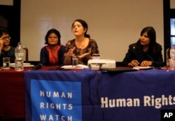 Heather Barr, center, a researcher at the New York-based Human Rights Watch, speaks during the release of a report on child marriage in Nepal in Kathmandu, Nepal, Sept. 8, 2016.