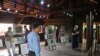 Guests observing the portraits of advocates for peace in Cambodia at the Cambodia Peace Gallery in Battambang. (Hor Singhuo/VOA)