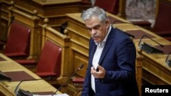 FILE - Civil Protection Minister Nikos Toskas delivers a speech during a parliament session in Athens, Greece, June 21, 2018. 