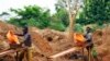 FILE - Gold miners sift through sandy soil as they work at an excavation site at a small scale mine in Bugiri, 348 km (216 miles) east of Kampala, Uganda's capital, Feb. 5, 2013. 