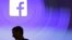 FILE - Facebook CEO Mark Zuckerberg walks at the company's headquarters in Menlo Park, California, April 4, 2013. 