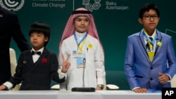 From left, Huang Jiangcheng of China, Fareed Mohammed Felemban of Saudi Arabia and Thanh Theerapasiri of Thailand, are pictured after speaking at a youth session during the COP29 U.N. Climate Summit, Nov. 18, 2024, in Baku, Azerbaijan.