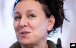 Polish author Olga Tokarczuk smiles during a press conference in Bielefeld, Germany, Thursday, Oct 10, 2019. Tokarczuk has been named recipient of the 2018 Nobel Prize in Literature.