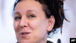 Polish author Olga Tokarczuk, recipient of the 2018 Nobel Prize in Literature, smiles during a press conference in Bielefeld, Germany, Thursday, Oct 10, 2019 