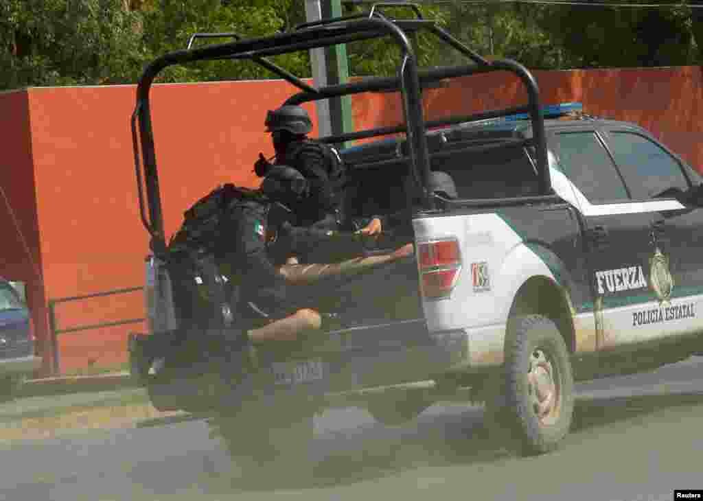 Policemen protect a colleague who was wounded during a prison riot as he is rushed to a hospital, in Ciudad Victoria, in Tamaulipas state, Mexico, June 6, 2017.