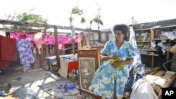 Lisau Manses hangs laundry inside in the remains of her house on the island of Efate, Vanuatu, March 21, 2015.