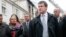  French Interior Minister Emmanuel Valls (R) and Justice Minister Christiane Taubira (L) visit the scene of a Roma squat in which a fire broke out in Lyon, France, May 13, 2013.