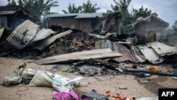 FILE - Burnt-down houses are seen following an attack allegedly perpetrated by the Allied Democratic Forces, in the village of Manzalaho near Beni, Democratic Republic of Congo, Feb. 18, 2020. ADF is accused of multiple deadly attacks in the area. 