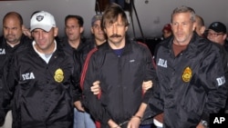 This Nov. 16, 2010, file photo, provided by the Drug Enforcement Administration (DEA), shows Russian arms trafficking suspect Viktor Bout, center, led by DEA officers off a flight From Bangkok to New York after his extradition to face terrorism charges in
