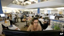 FILE - Tara Ostermann works at her desk at the Walmart.com office in San Bruno, California.