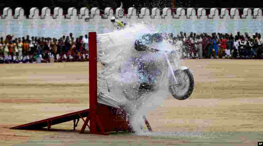 An Indian army officer performs a stunt on a motorcycle during a function to mark India's Independence Day in Bangalore, India.