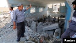 Men remove rubble at a water plant in Raqqa, after what locals said was an air raid by Syrian government forces that targeted the plant, resulting in a water cutoff for residents.