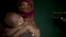 In this June 25, 2018, photo, "S" holds her baby boy as she sits in her shelter in Balukhali refugee camp in Bangladesh.