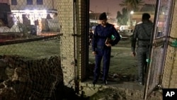 FILE - Iraqi security forces inspect the site of a suicide bomb attack in Baghdad, Iraq, May 9, 2019.