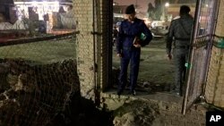 Iraqi security forces inspect the site of a blast in Baghdad, Iraq, May 9, 2019.