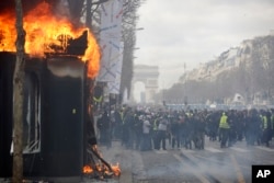 A newsstand burns during a yellow vests demonstration on Champs Elysees avenue in Paris, France, March 16, 2019.