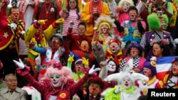 Clowns pose for a photo as they rally for peace during the 18th Latin American clown convention or "Fair of laughter" at the Mother Monument in Mexico City October 23, 2013. The convention will be held from October 21 to 24 in Mexico City. 