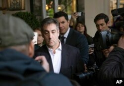 FILE - Michael Cohen, former attorney to President Donald Trump, leaves his apartment building before beginning his prison term, May 6, 2019, in New York.