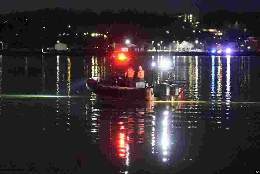 A boat works the scene near Ronald Reagan Washington National Airport, Jan. 30, 2025, in Arlington.