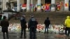 Police patrol one of the memorial sites for the victims of the recent attacks in Brussels at the Place de la Bourse in Brussels, March, 25, 2016. 